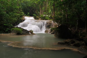 Private Erawan Waterfalls tour from Bangkok ✅. Walk to 7th level, swim at the falls, enjoy a natural 'Fish spa'. Optional: Bridge River Kwai and boat tour.